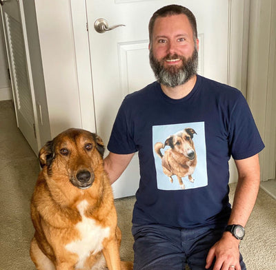 man proudly wearing his custom dog art t-shirt with his cute dog